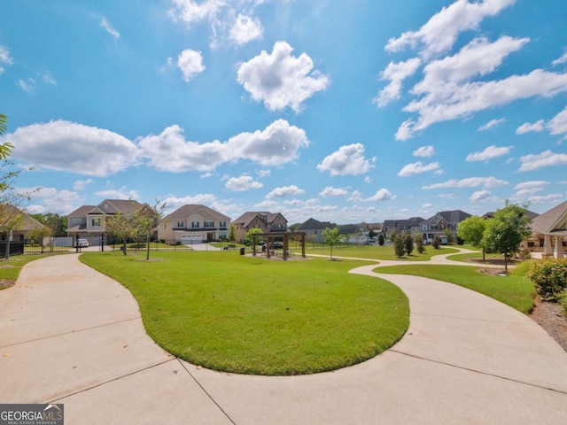 view of property's community featuring a lawn