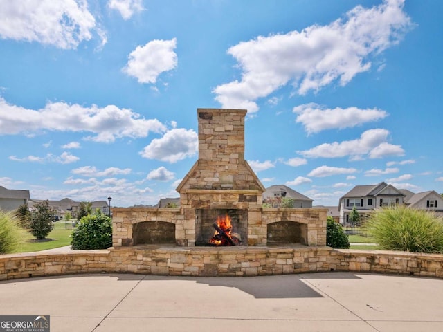 view of patio with an outdoor stone fireplace