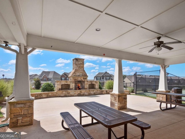 view of patio / terrace featuring an outdoor stone fireplace