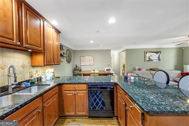 kitchen featuring black dishwasher, sink, and kitchen peninsula