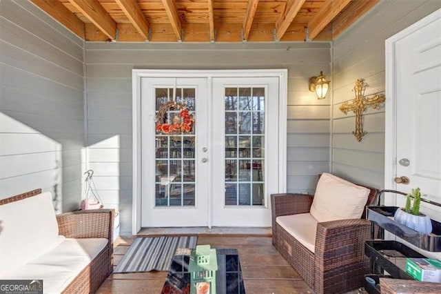 property entrance featuring outdoor lounge area and french doors