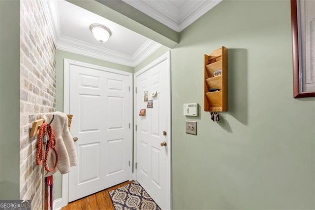 doorway to outside featuring crown molding and light hardwood / wood-style flooring