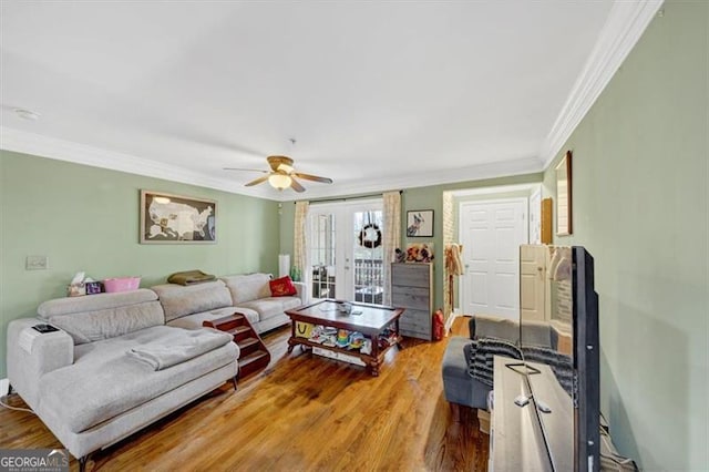 living room featuring ornamental molding, hardwood / wood-style floors, ceiling fan, and french doors