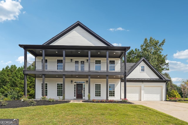 view of front of home with a front yard, a standing seam roof, a balcony, and an attached garage