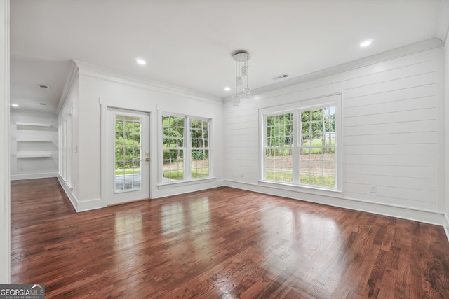 interior space with dark wood-type flooring, visible vents, plenty of natural light, and crown molding