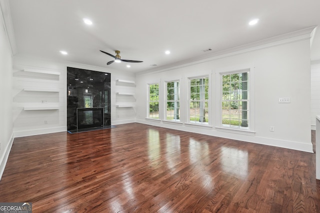 unfurnished living room featuring ornamental molding, a fireplace, and built in features