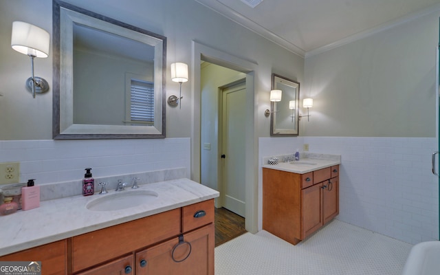 bathroom with vanity, ornamental molding, and tile walls