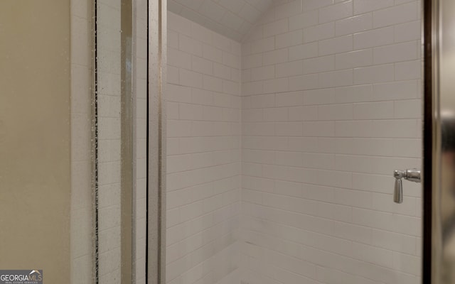 interior details featuring a tile shower