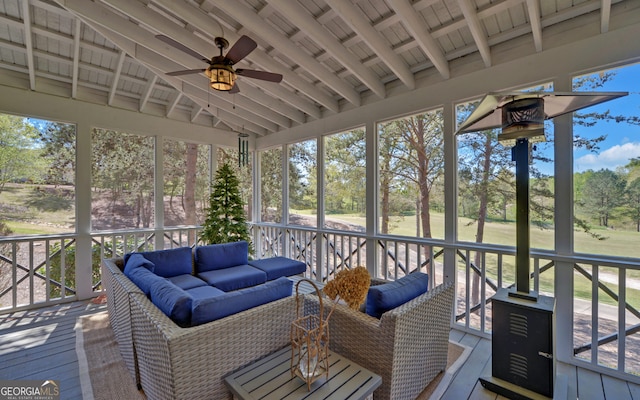 sunroom featuring lofted ceiling with beams, wooden ceiling, and ceiling fan