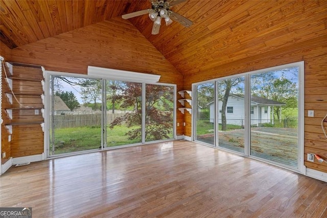 unfurnished sunroom with ceiling fan, vaulted ceiling, and wooden ceiling