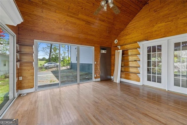 unfurnished sunroom with vaulted ceiling, a wealth of natural light, ceiling fan, and wood ceiling