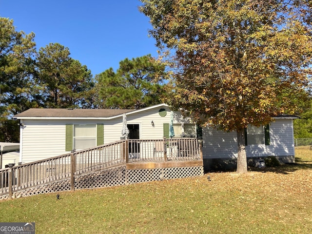 manufactured / mobile home with a deck and a front yard