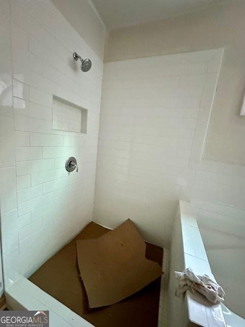 bathroom with a tile shower