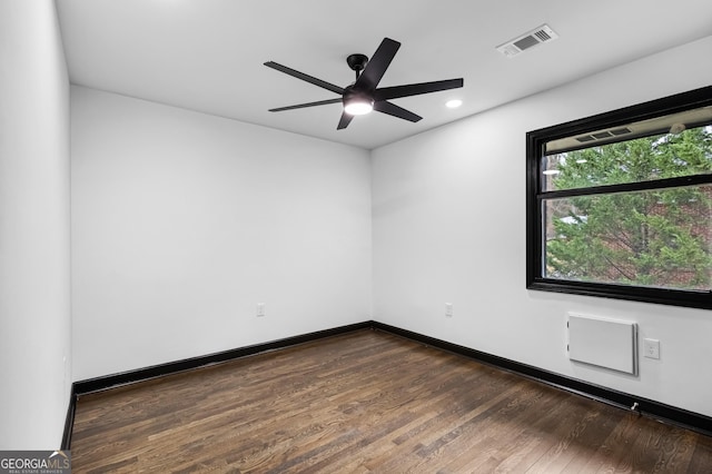 unfurnished room with ceiling fan and dark hardwood / wood-style floors