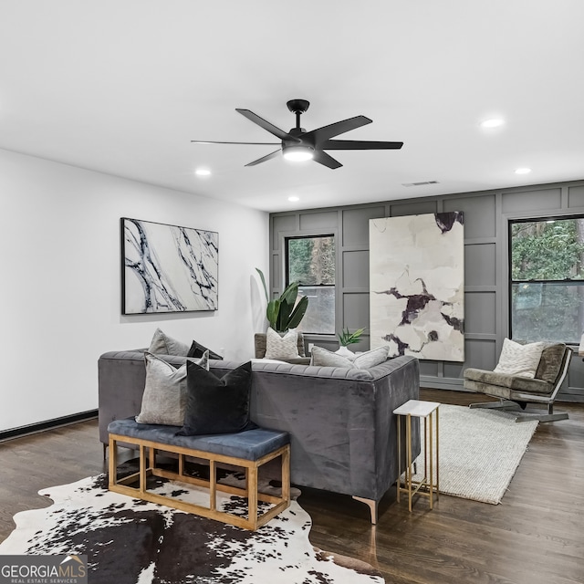 living room with dark hardwood / wood-style floors and ceiling fan