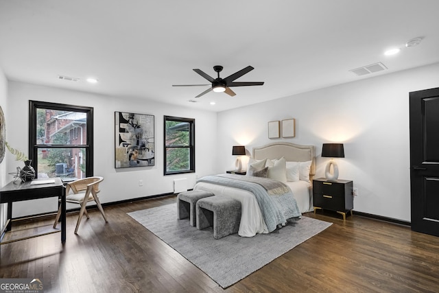 bedroom with dark hardwood / wood-style floors and ceiling fan