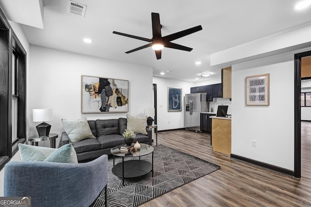 living room with hardwood / wood-style flooring and ceiling fan