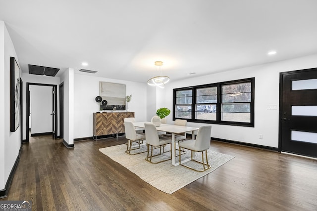 dining area featuring dark wood-type flooring