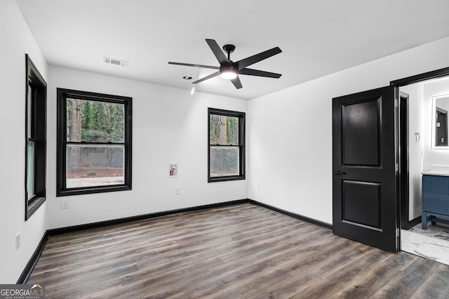 spare room featuring hardwood / wood-style floors and ceiling fan