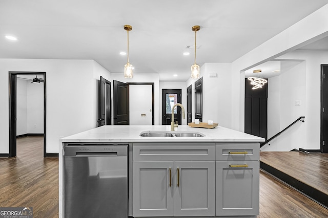 kitchen with gray cabinetry, sink, a kitchen island with sink, and stainless steel dishwasher