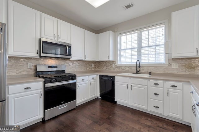 kitchen featuring sink, dark wood-type flooring, appliances with stainless steel finishes, tasteful backsplash, and white cabinets