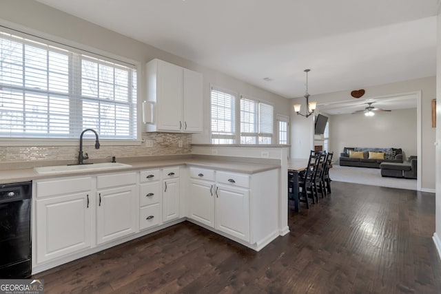 kitchen featuring sink, white cabinetry, dark hardwood / wood-style flooring, black dishwasher, and pendant lighting