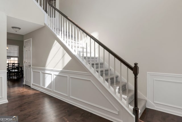 stairway with hardwood / wood-style floors