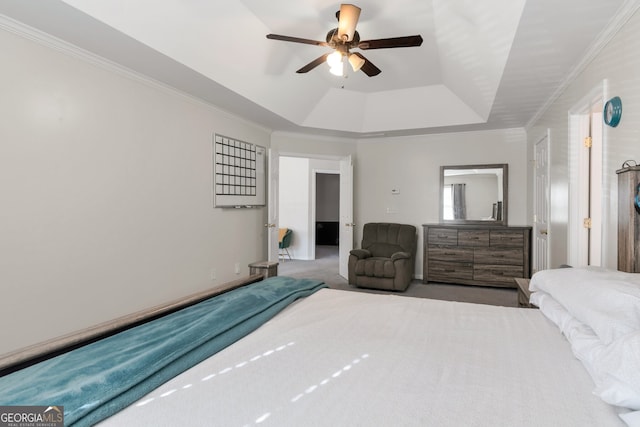 bedroom with crown molding, carpet flooring, a tray ceiling, and ceiling fan