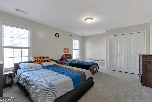 carpeted bedroom with a closet