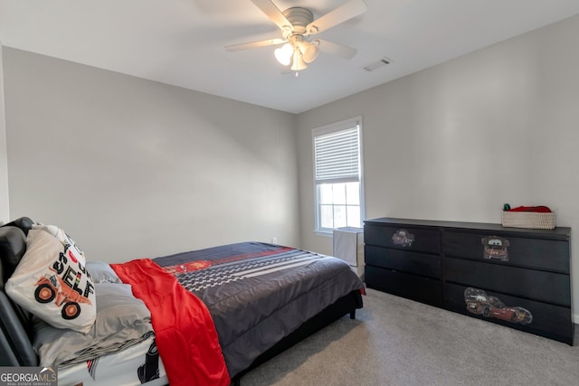 bedroom featuring ceiling fan and carpet