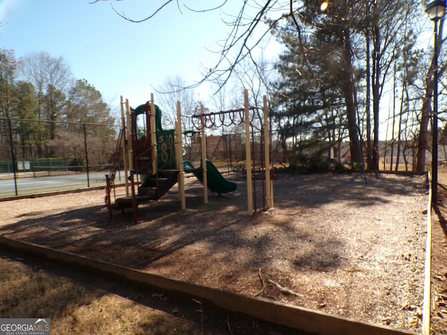 view of jungle gym with tennis court