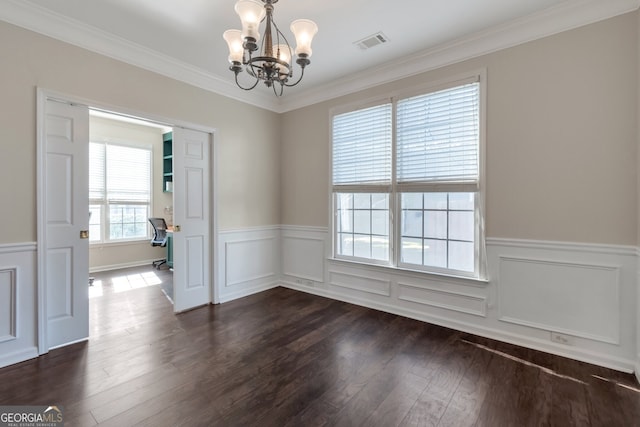 unfurnished dining area featuring dark hardwood / wood-style flooring, ornamental molding, and a chandelier