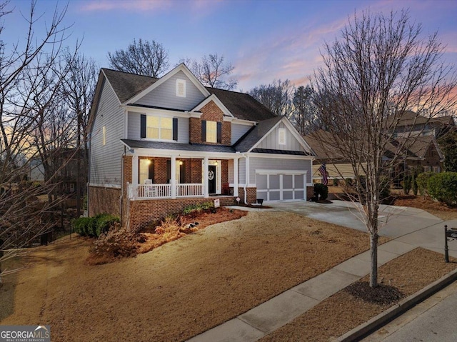 view of front of property featuring a porch and a garage