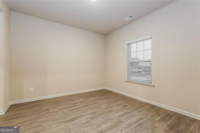 spare room with light hardwood / wood-style flooring