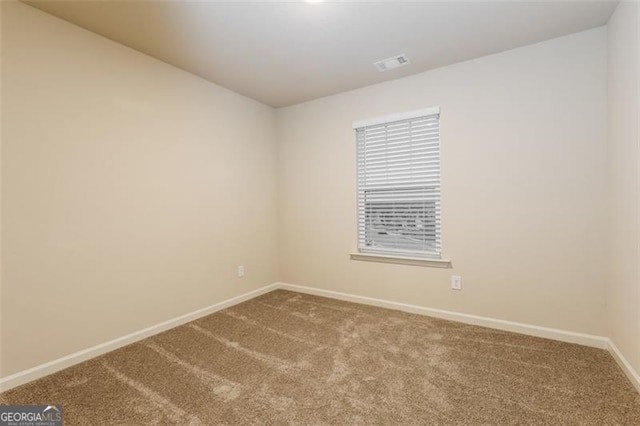 spare room featuring carpet floors