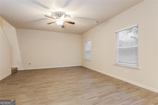 spare room with ceiling fan and light hardwood / wood-style floors