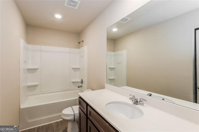 full bathroom featuring hardwood / wood-style flooring, vanity, toilet, and shower / bathing tub combination