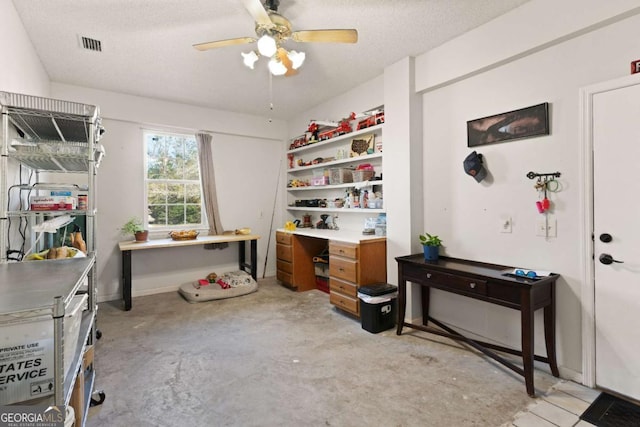 home office featuring ceiling fan and a textured ceiling