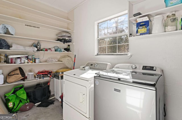 clothes washing area featuring independent washer and dryer