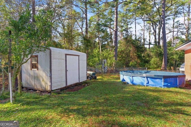 view of yard with a storage shed and a covered pool