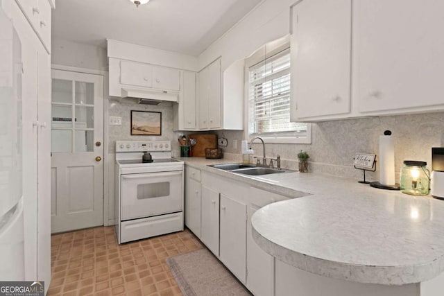 kitchen featuring tasteful backsplash, sink, electric range, and white cabinets