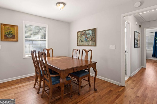 dining space with hardwood / wood-style flooring