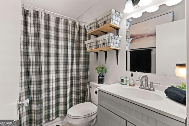 bathroom featuring vanity, curtained shower, and toilet