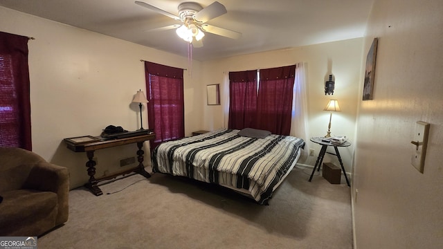 bedroom with ceiling fan and light carpet