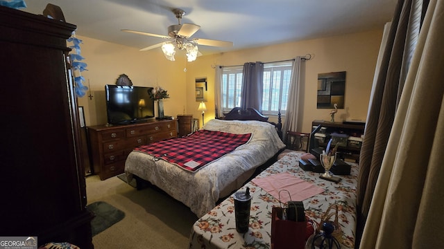 bedroom with ceiling fan and light colored carpet