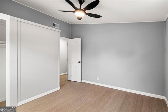 unfurnished bedroom featuring light hardwood / wood-style floors, a closet, and ceiling fan