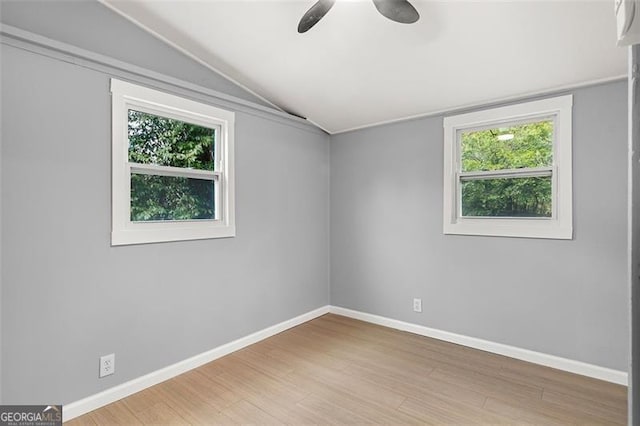 unfurnished room featuring lofted ceiling, hardwood / wood-style flooring, and ceiling fan