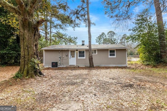 rear view of house featuring central AC