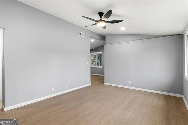 unfurnished room featuring ceiling fan, lofted ceiling, and light hardwood / wood-style flooring