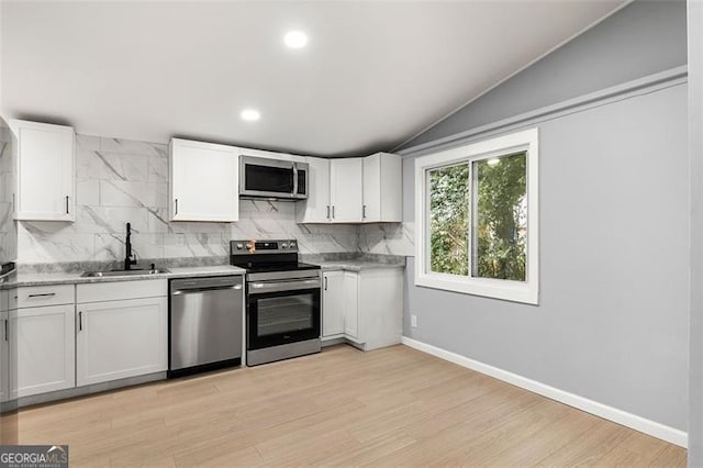 kitchen featuring white cabinetry, sink, tasteful backsplash, and appliances with stainless steel finishes